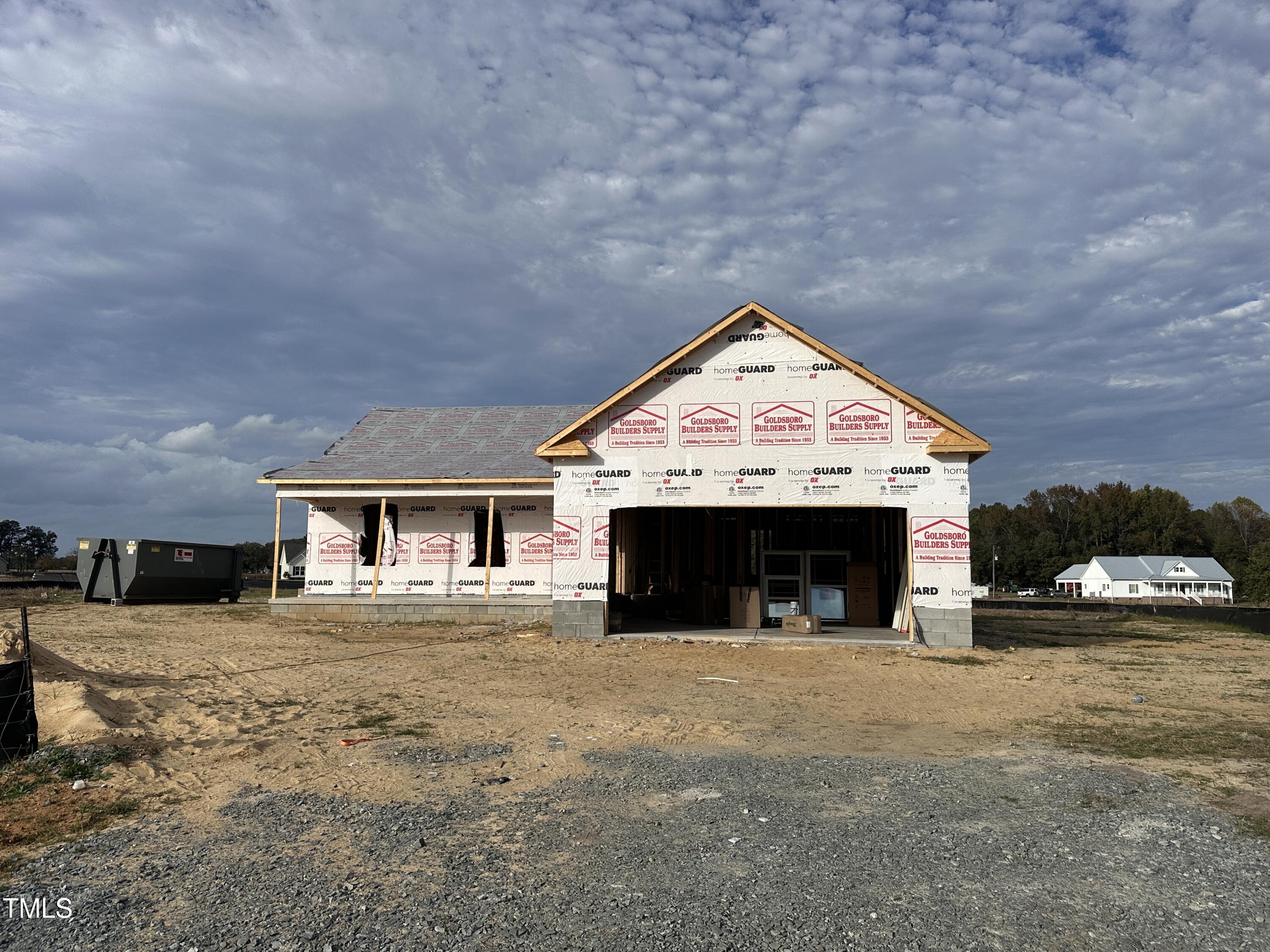 a view of house with yard and car parked