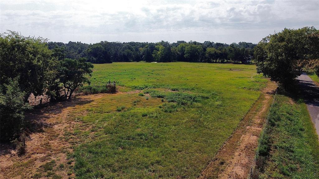 a view of a field with an ocean