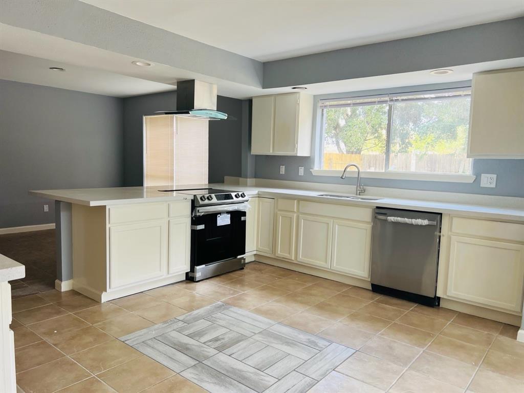 a kitchen with a stove sink and cabinets