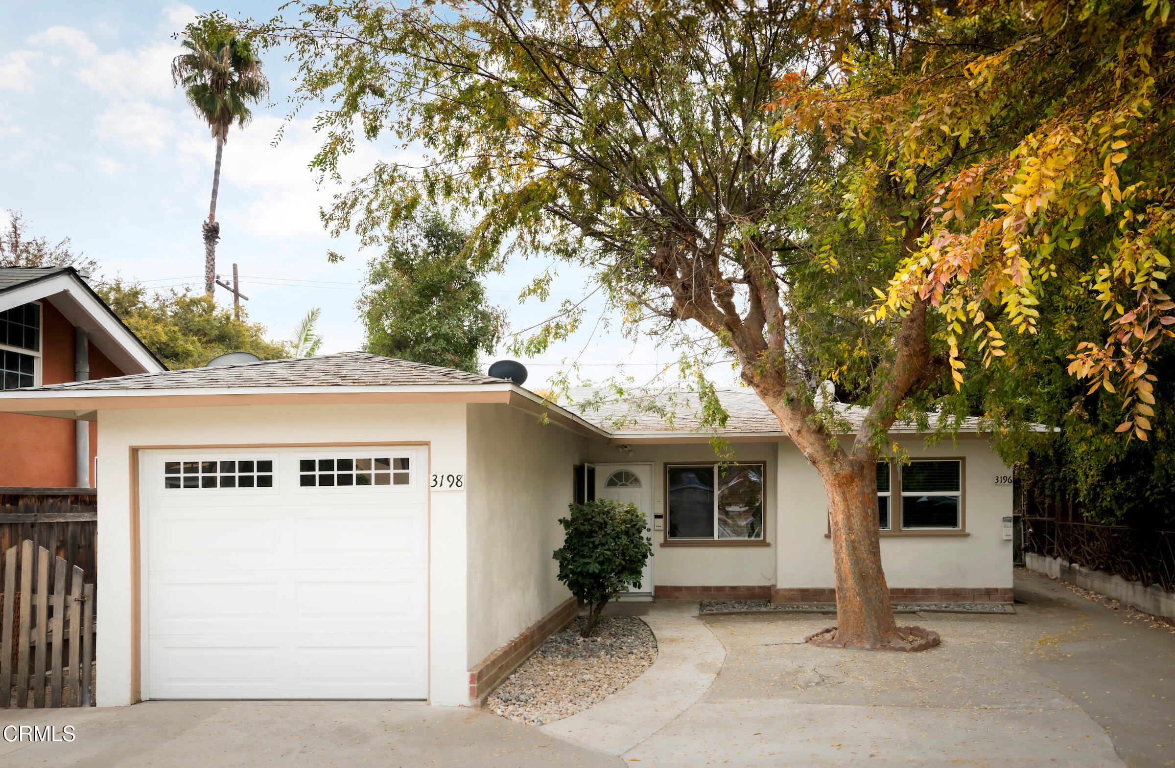 a view of a house with a tree