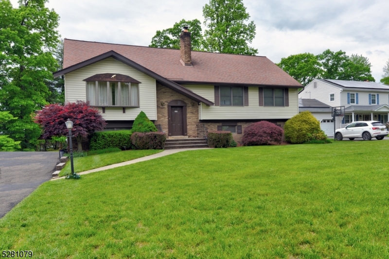 a front view of a house with a garden and plants