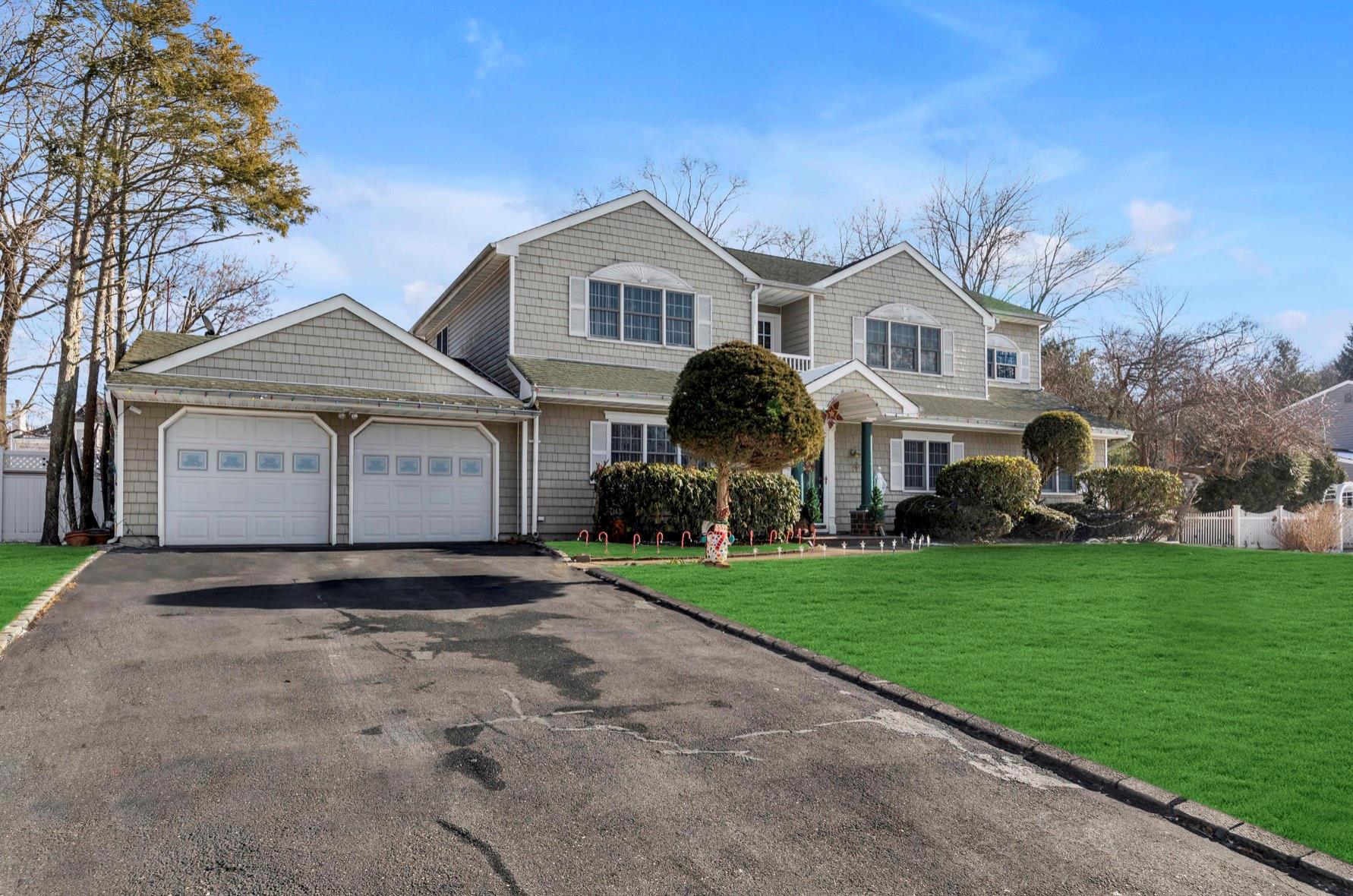 View of property with a front yard and a garage