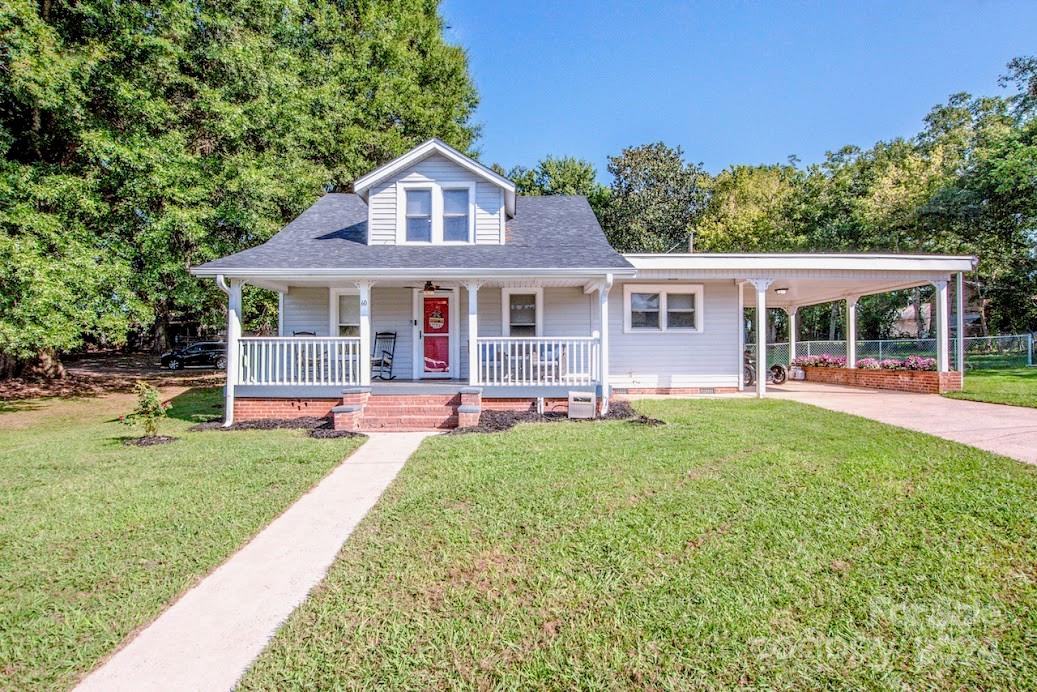 a view of a house with a yard porch and sitting area