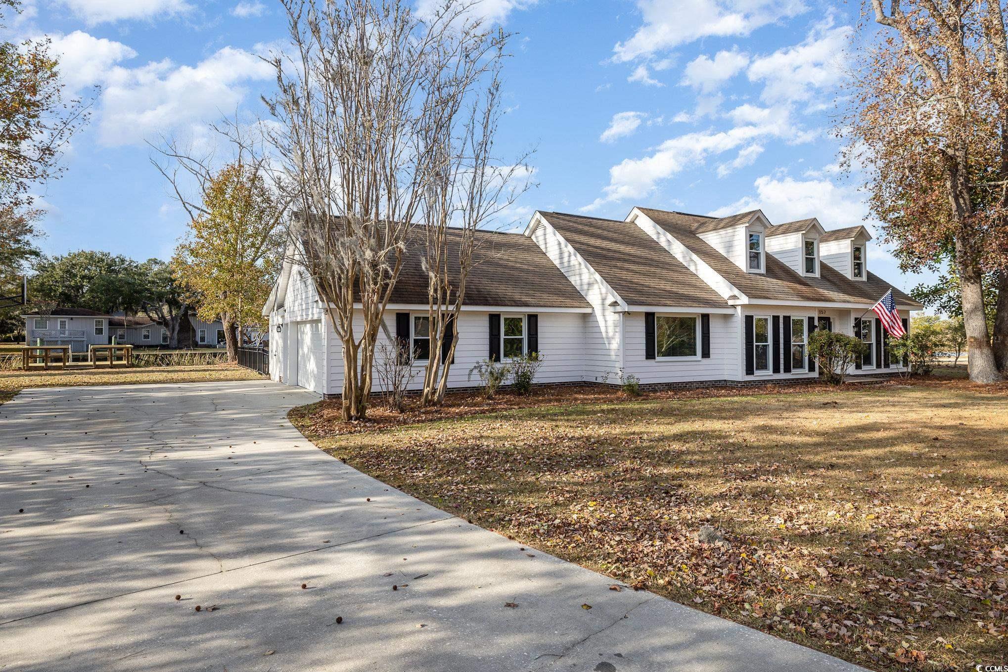 Cape cod home featuring a garage