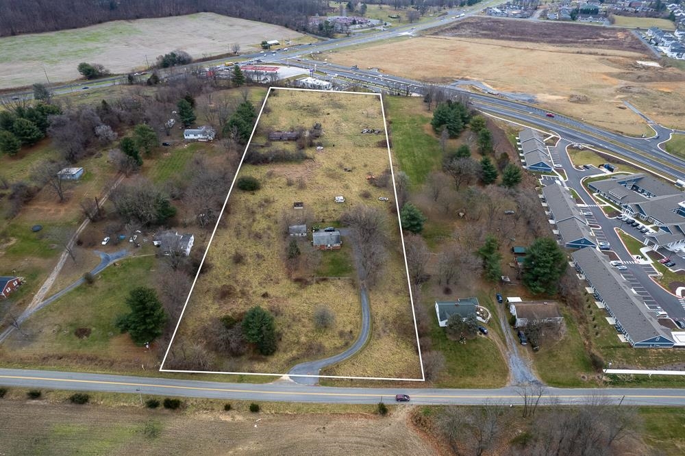 an aerial view of a residential houses with outdoor space