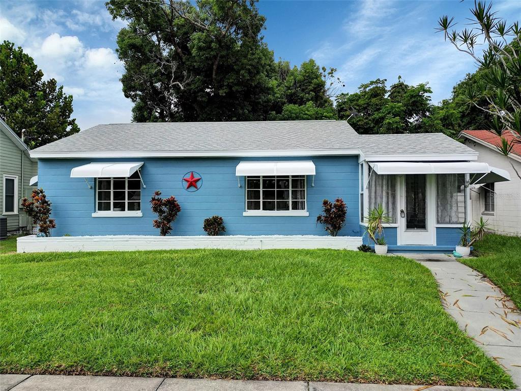 a front view of a house with a garden and porch