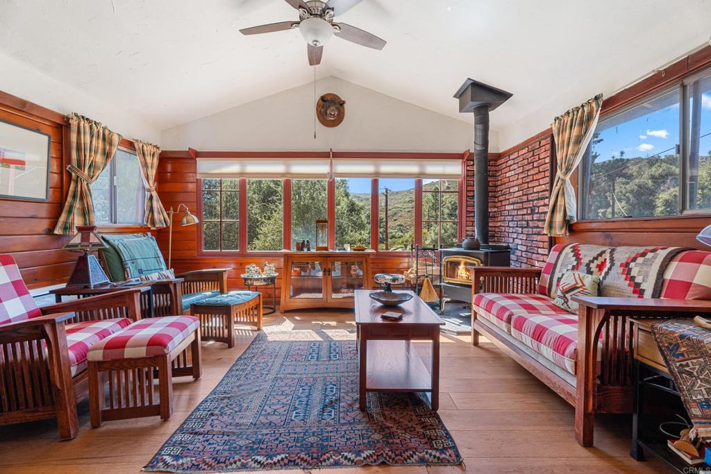 a living room with furniture a rug and a large window