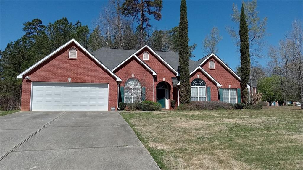 a front view of a house with yard and garage