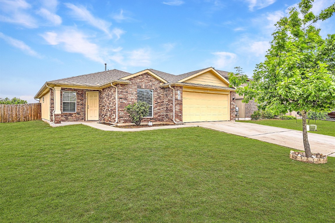 a front view of a house with a garden and yard