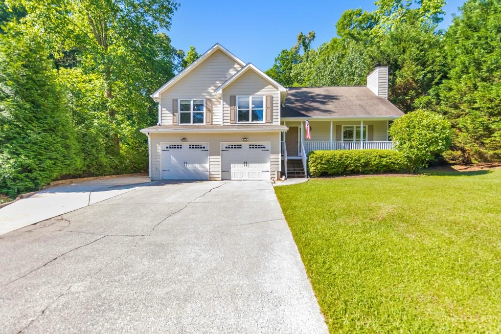 a front view of a house with yard and green space