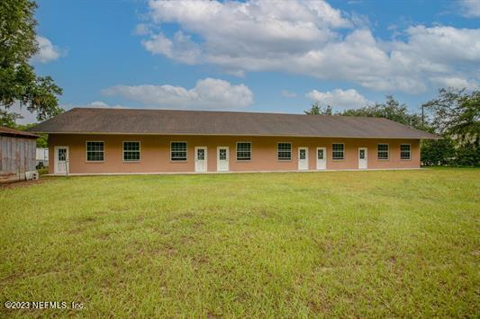 a front view of a house with yard and green space