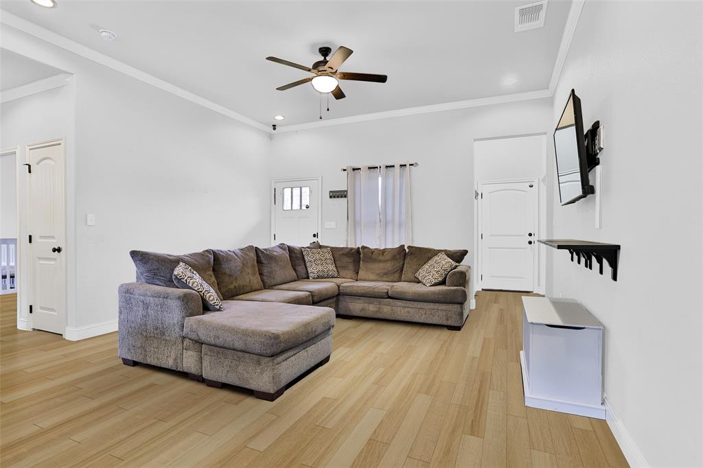 a living room with furniture and a ceiling fan