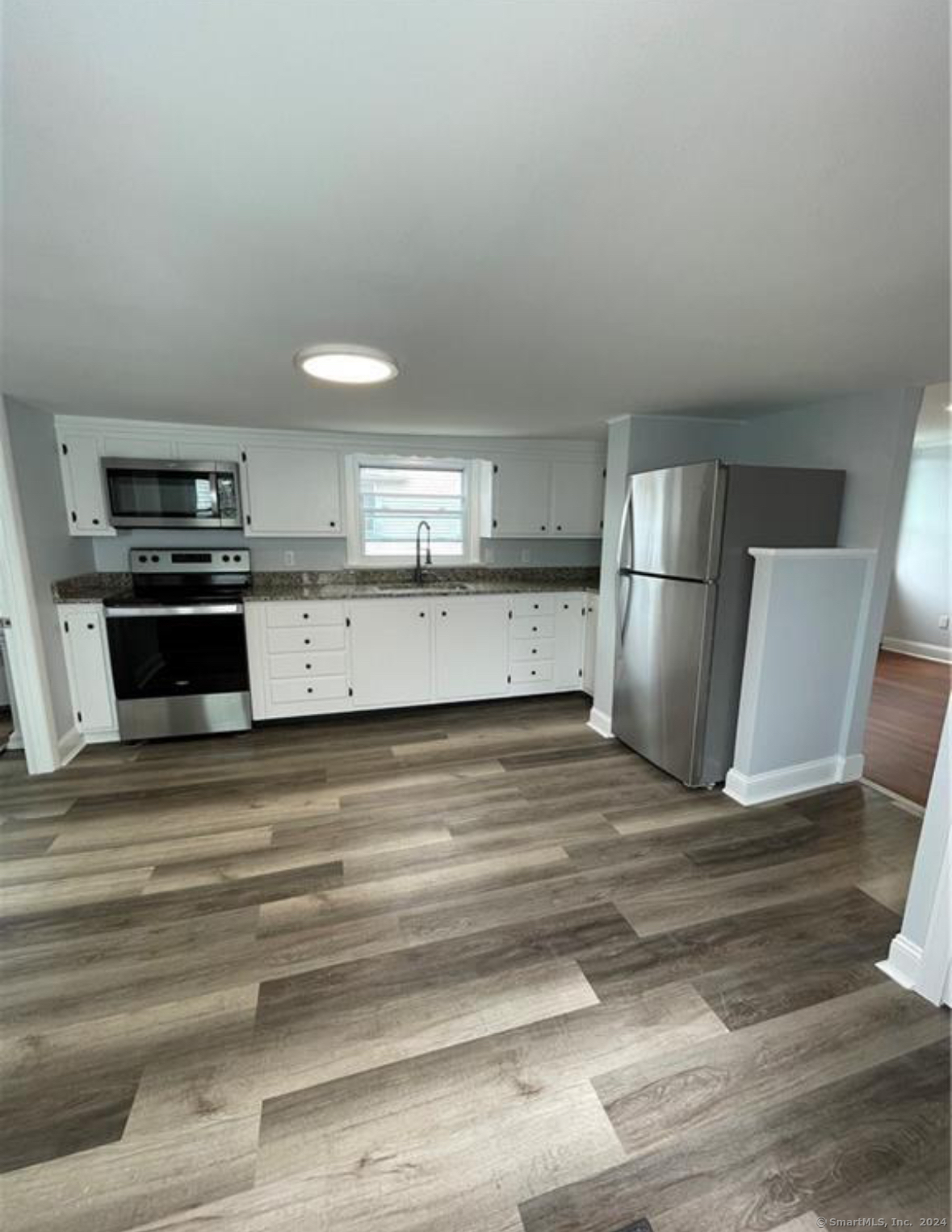 a kitchen with stainless steel appliances a refrigerator and a stove top oven