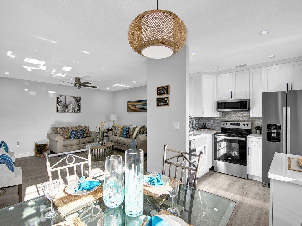 a living room with stainless steel appliances kitchen island granite countertop furniture and a kitchen view