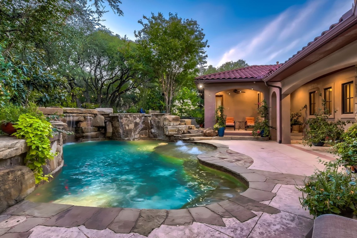 a view of a backyard with plants and a patio