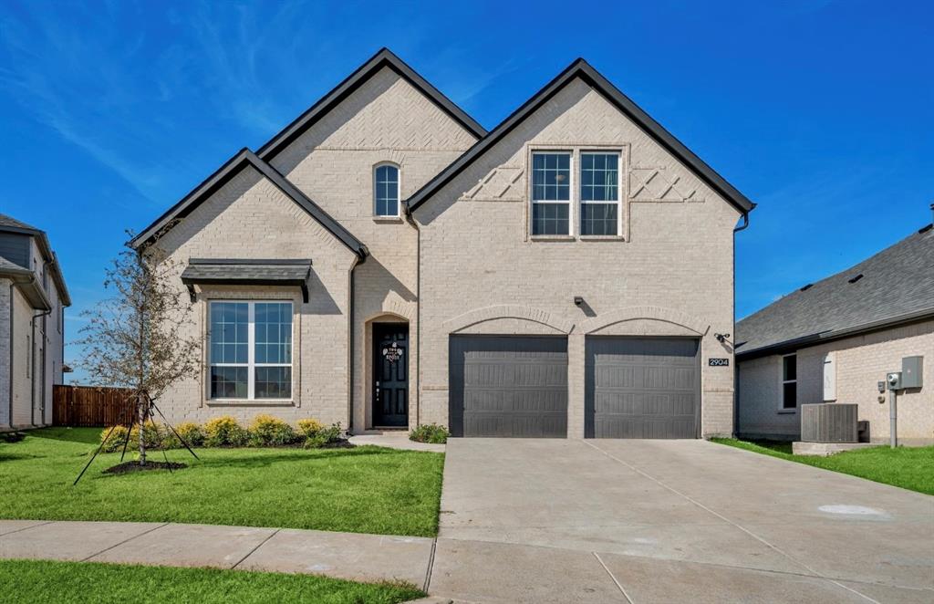 a view of a house with a yard and garage