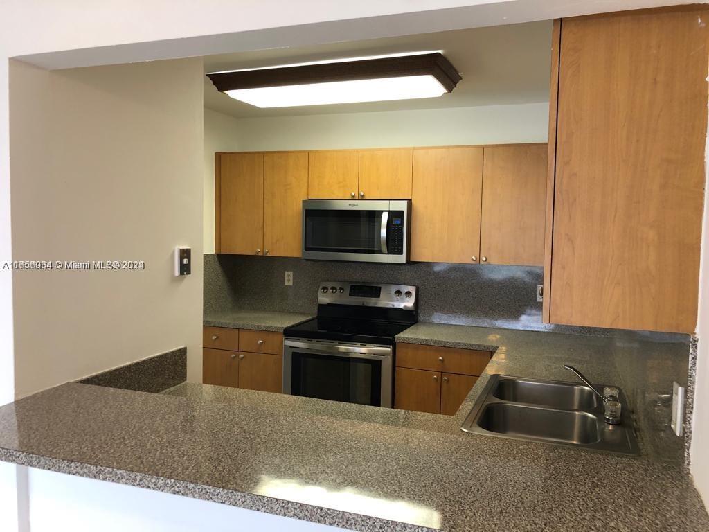 a kitchen with granite countertop a sink and a stove top oven