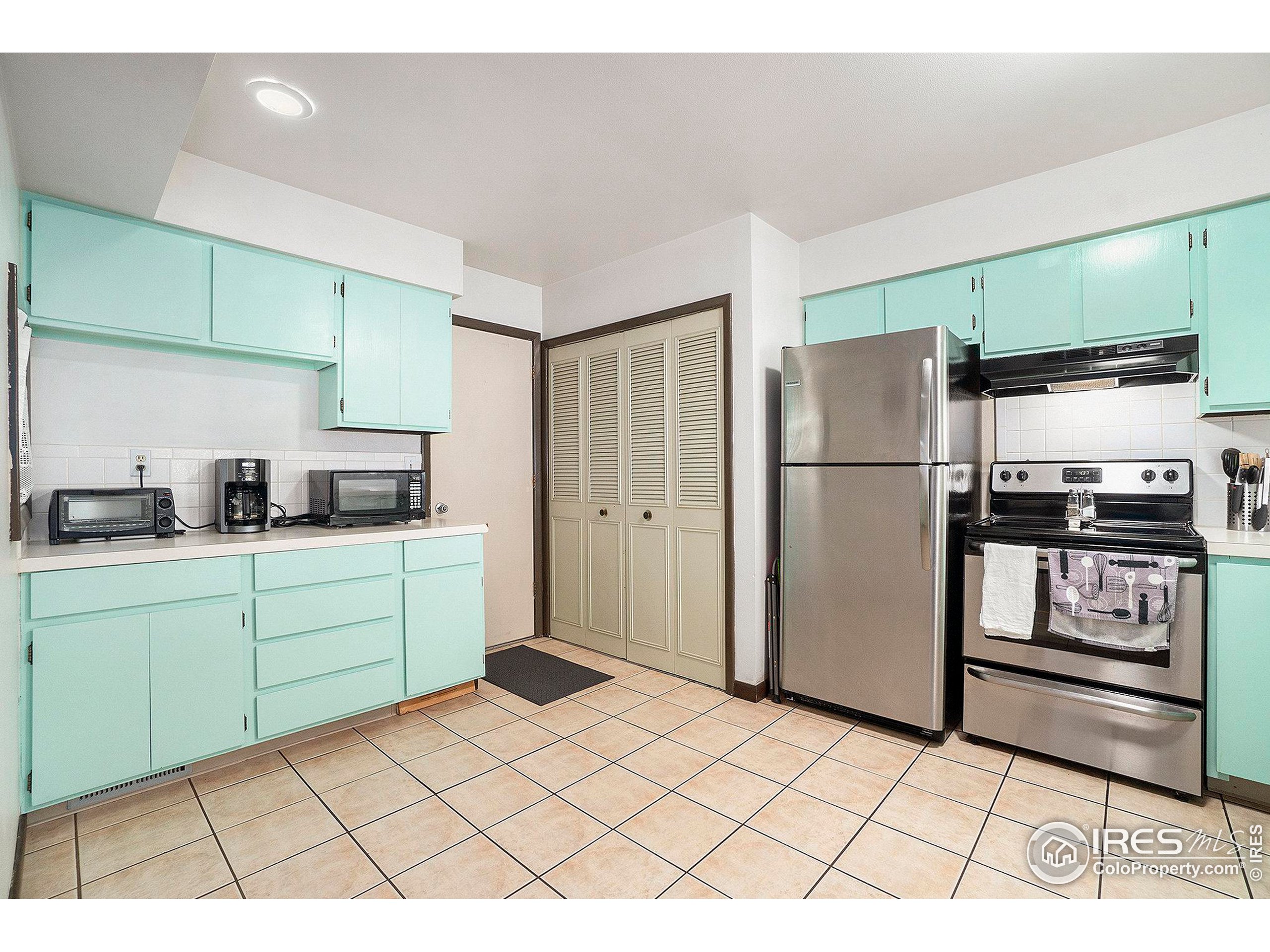 a kitchen with a refrigerator and cabinets