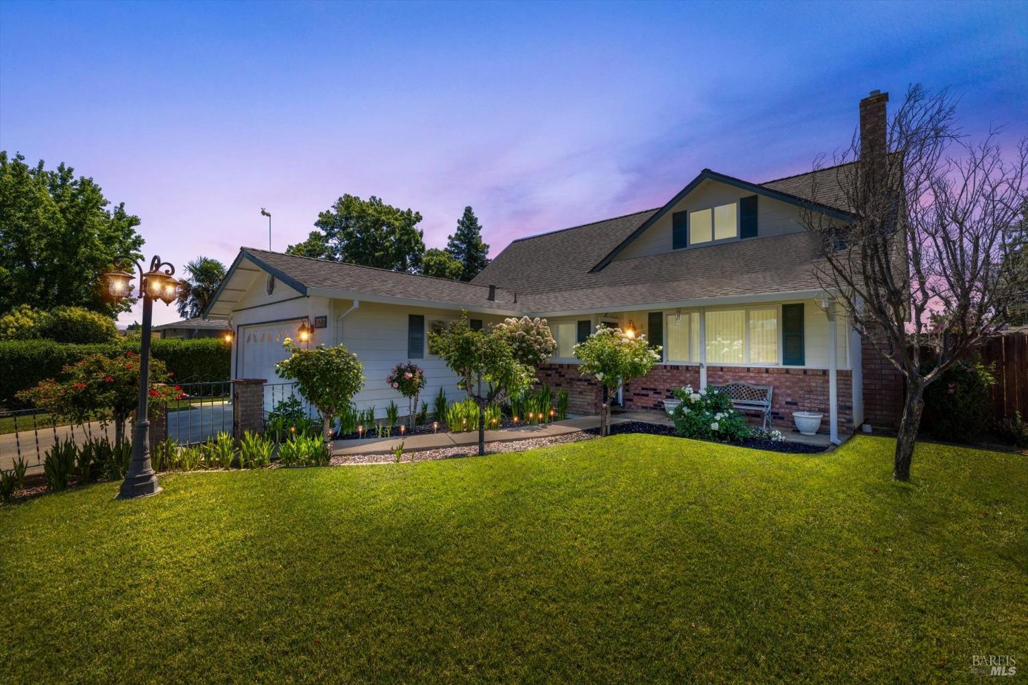 a front view of house with yard and outdoor seating