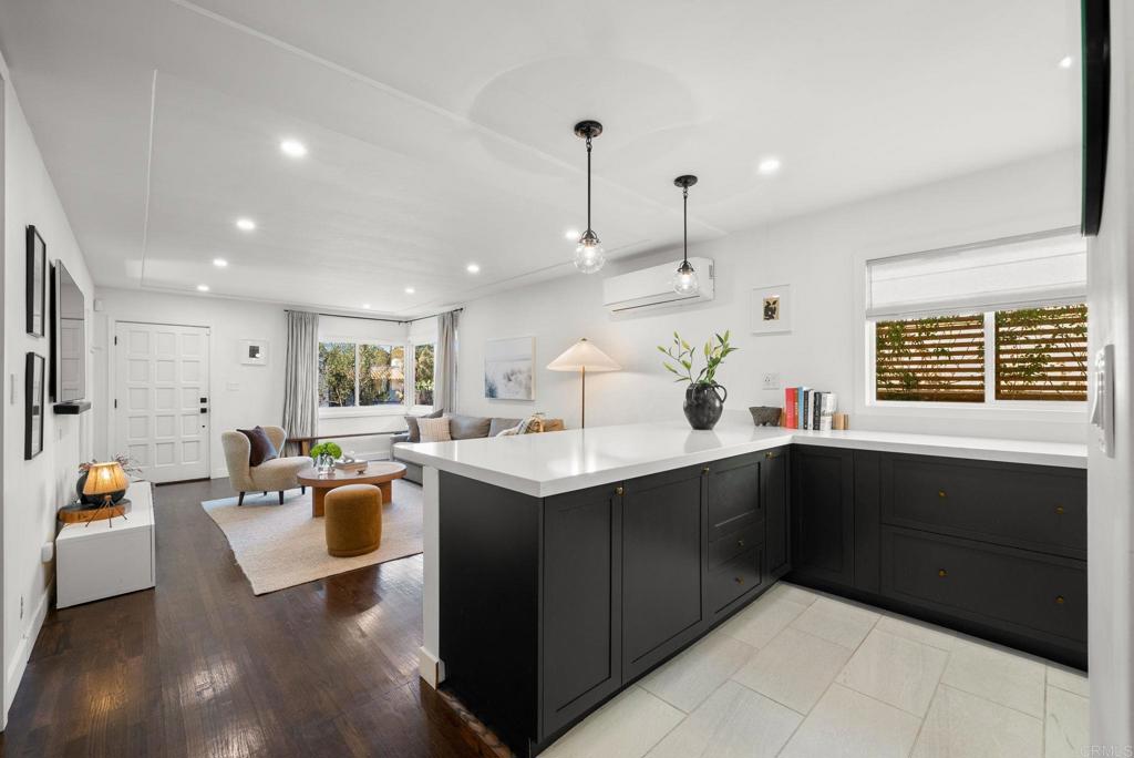 a kitchen with stainless steel appliances granite countertop a sink counter space dining table and chairs