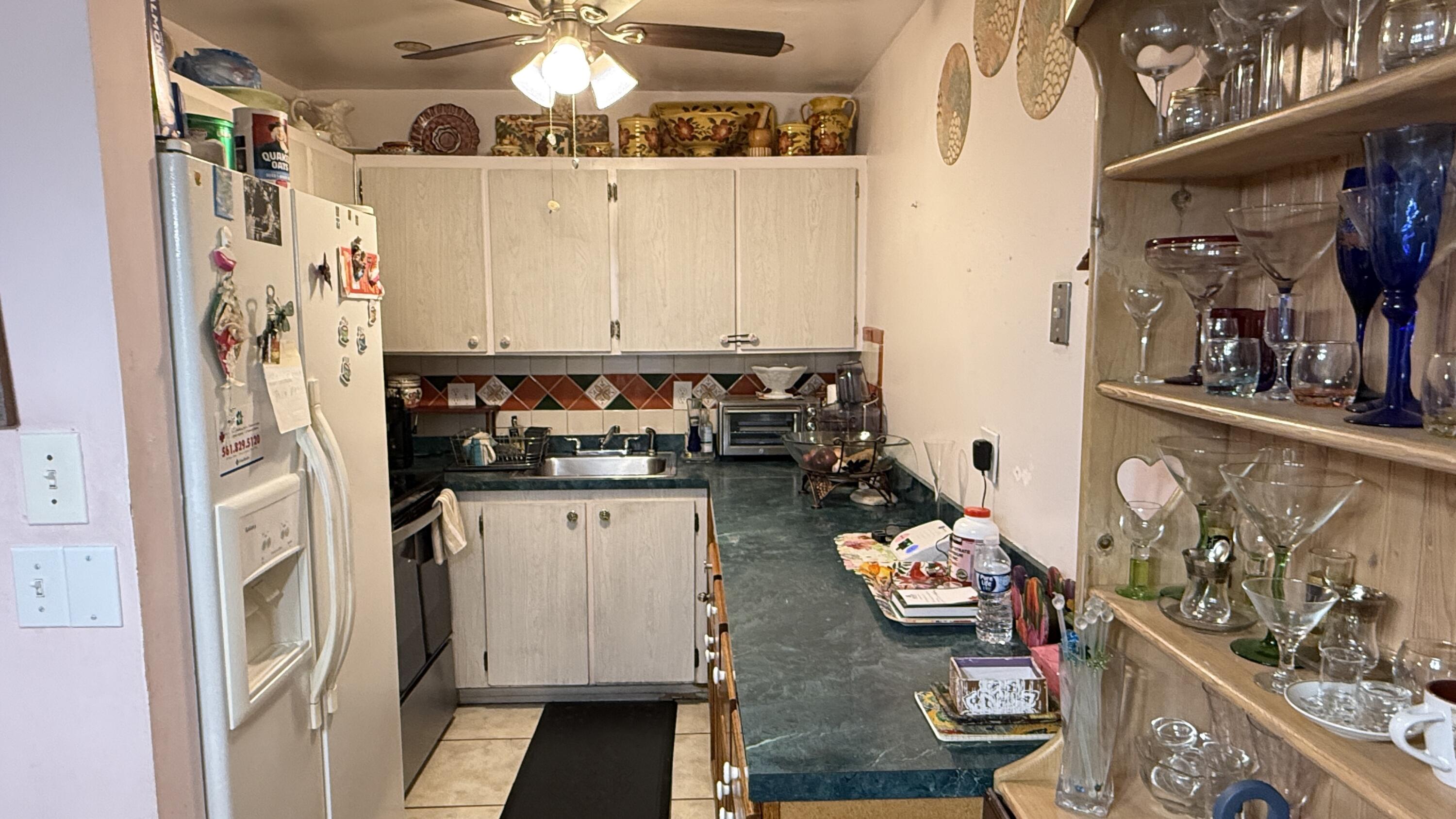 a kitchen with stainless steel appliances granite countertop a refrigerator and a stove