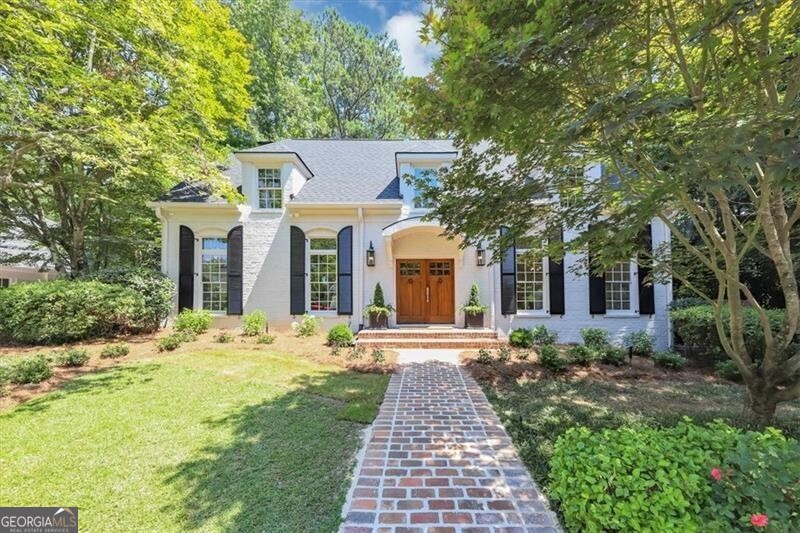 Beautiful painted brick home features charming "cobblestone" walkway