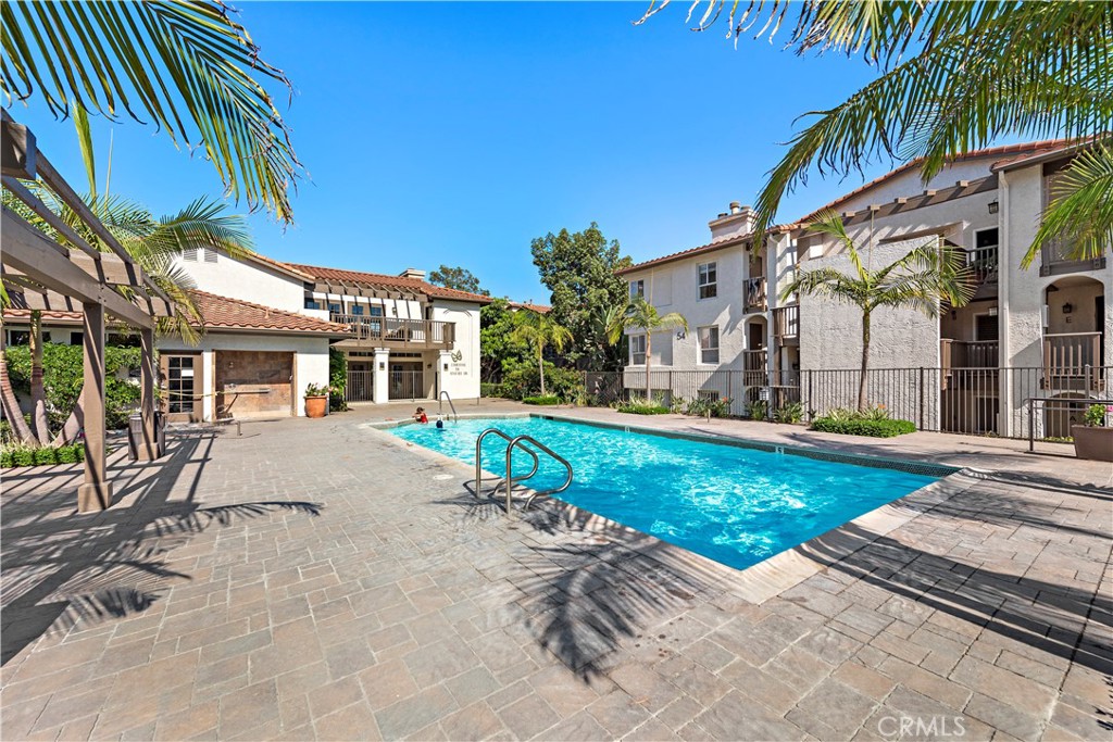 a view of a house with backyard and swimming pool