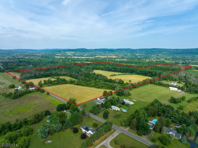 an aerial view of a residential houses with outdoor space and street view