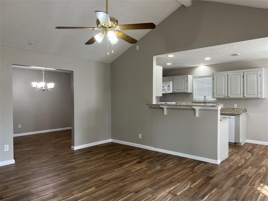 a view of kitchen with granite countertop cabinets and wooden floor