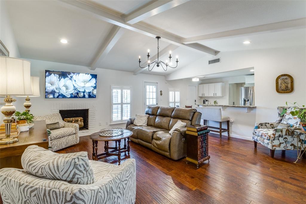 a living room with furniture a fireplace and wooden floor