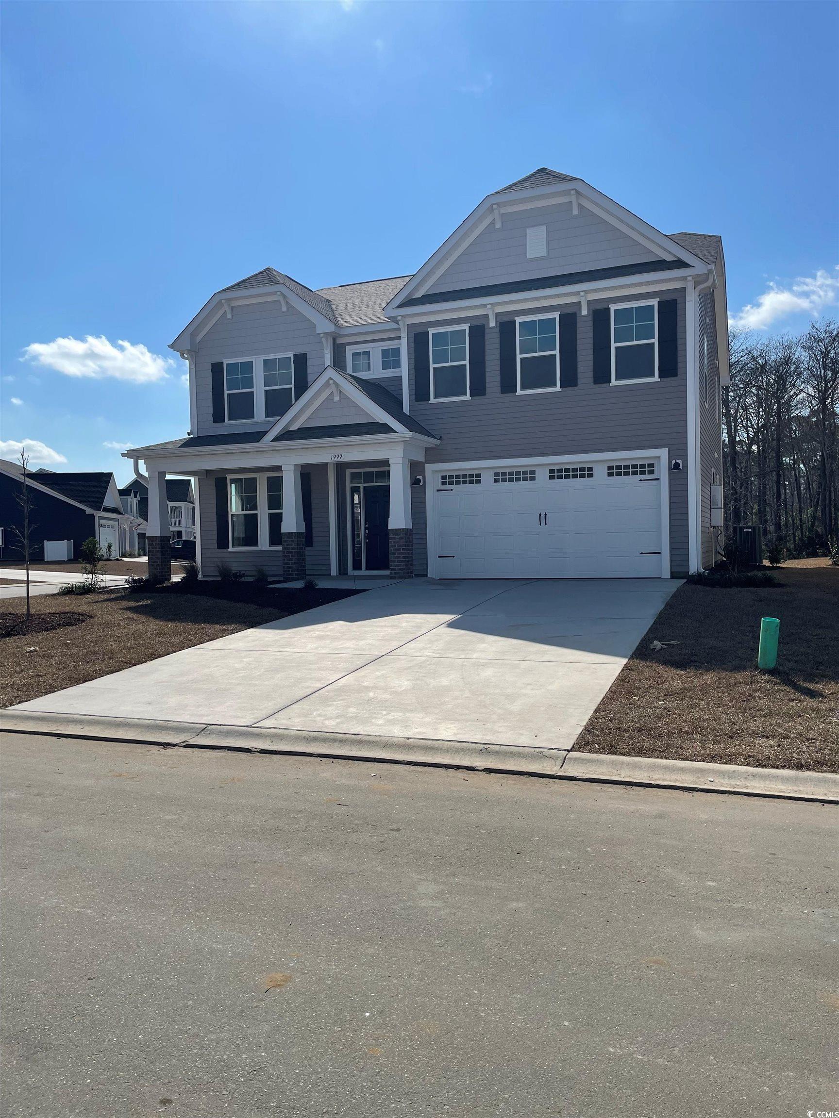 View of front of house with a garage and central A