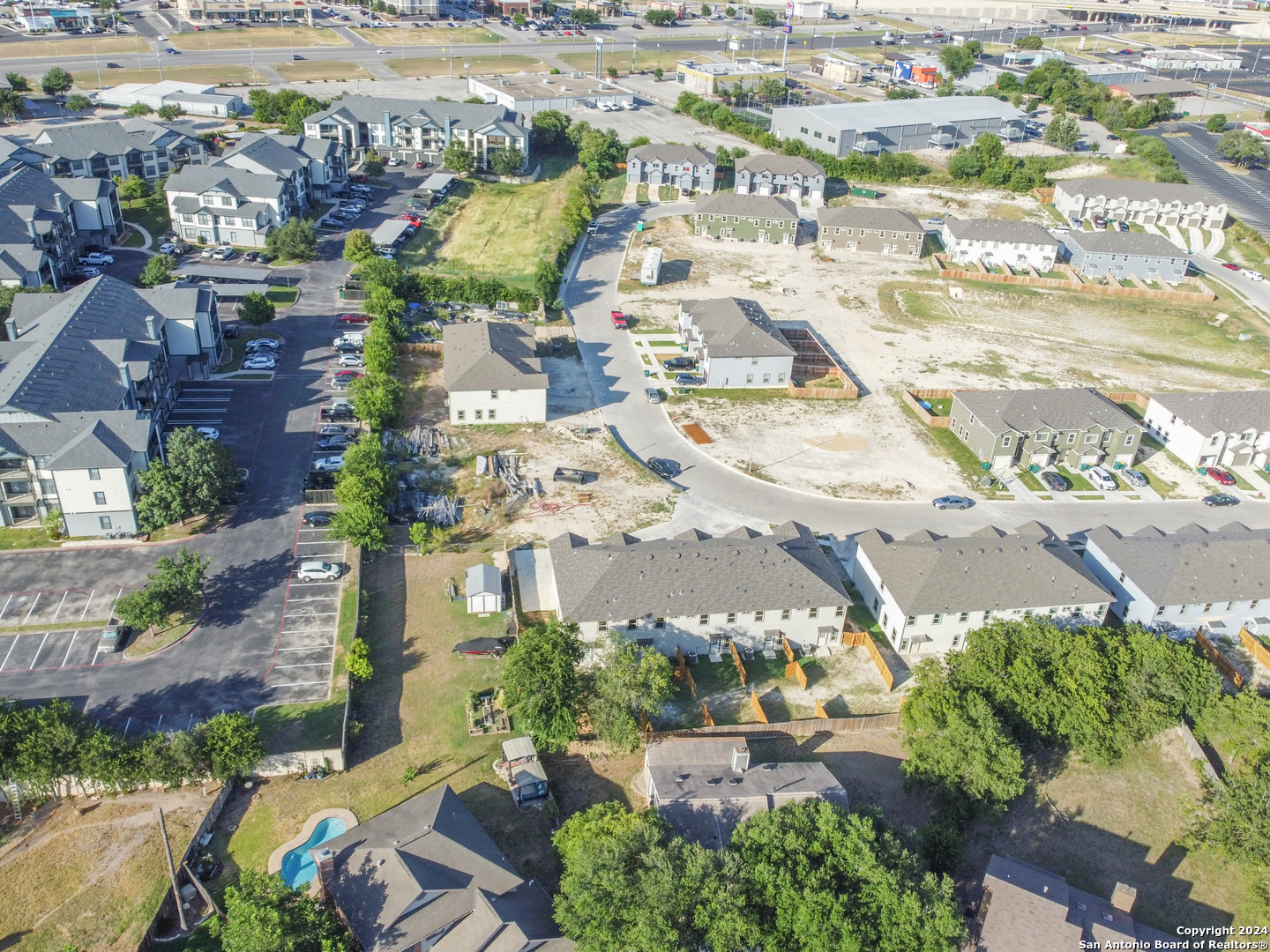 an aerial view of residential houses with outdoor space