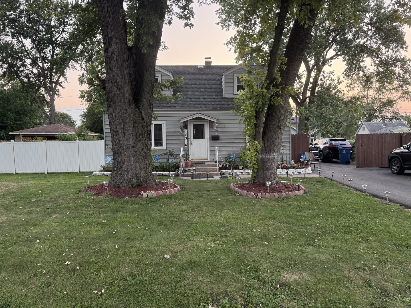 a view of a house with a yard and a tree