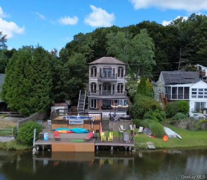 a aerial view of a house with swimming pool and a yard