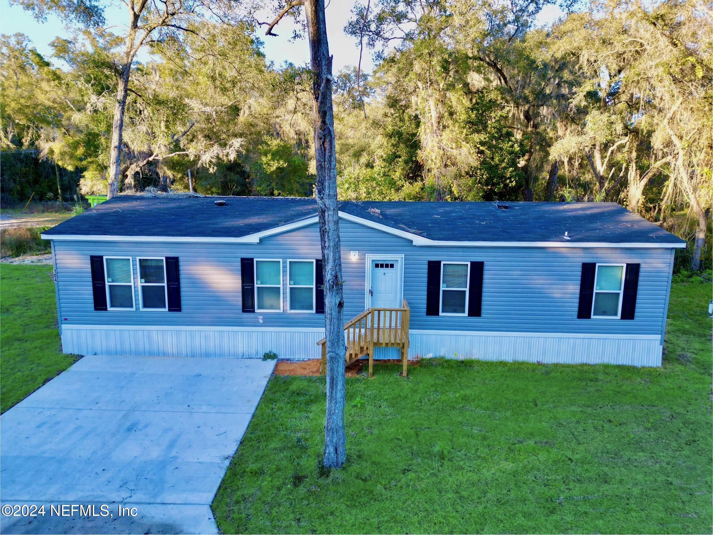 a view of a yard in front of a house with a yard