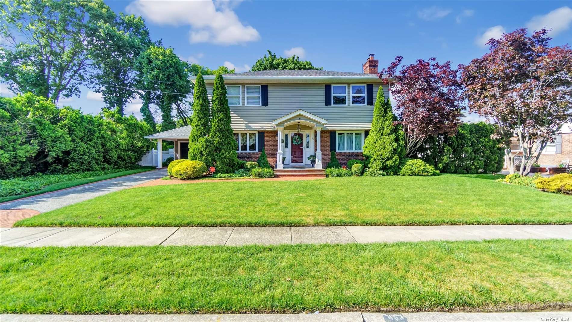 a front view of house with yard and green space