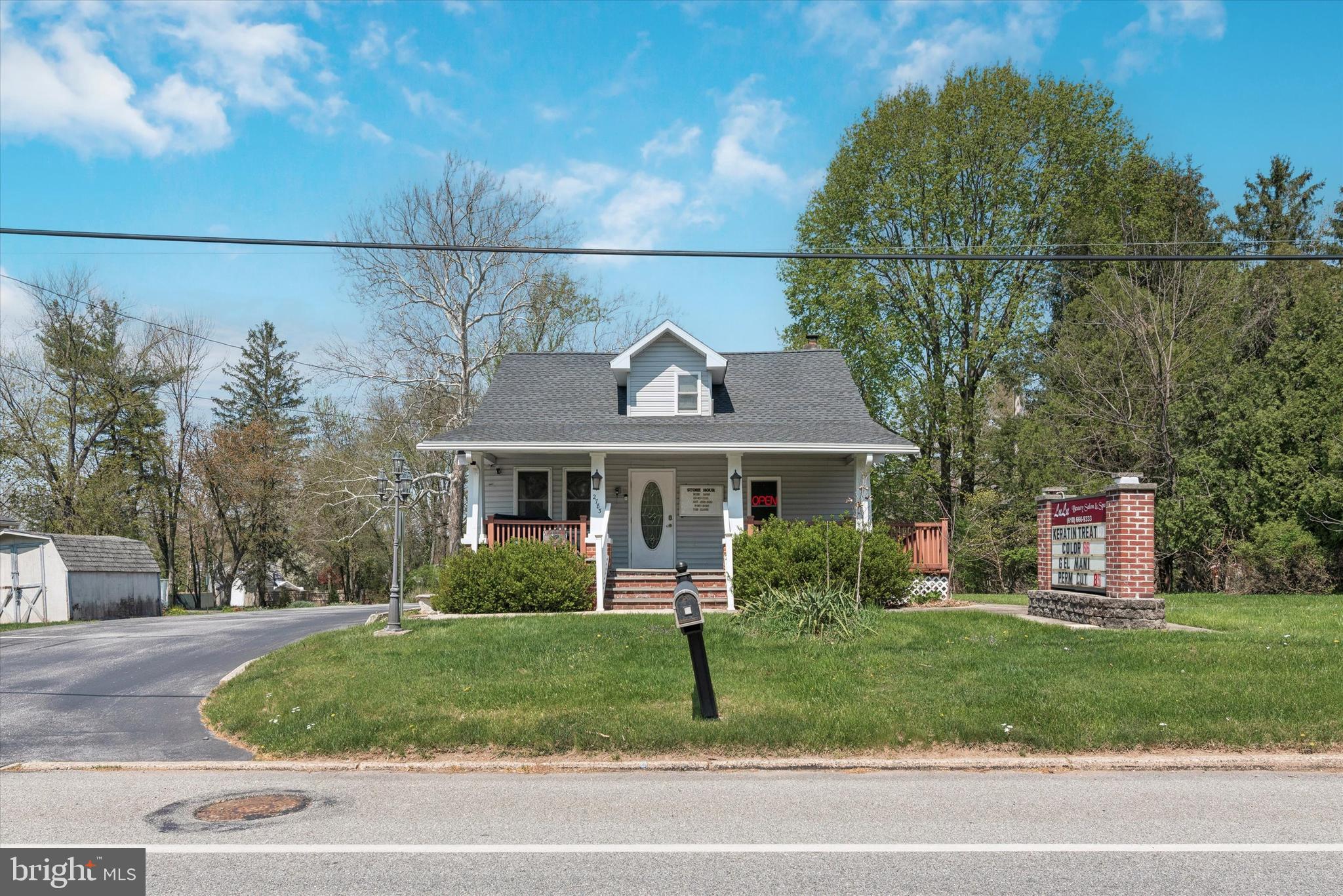 a front view of a house with a garden