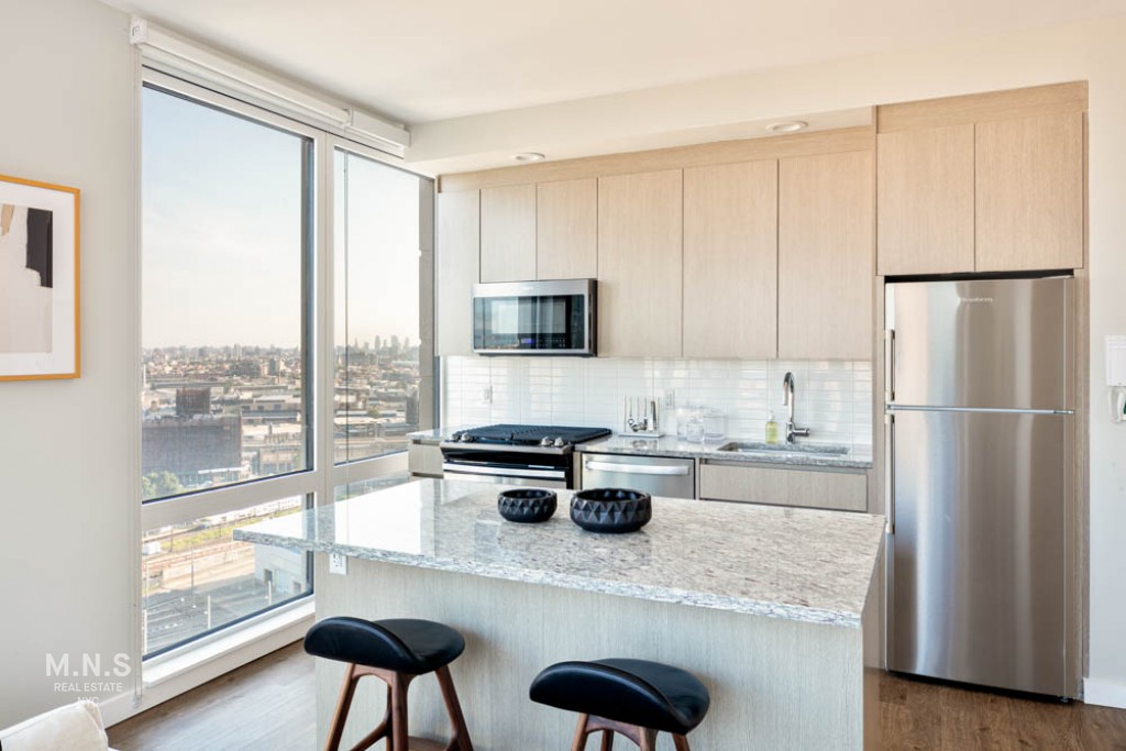 a kitchen with appliances cabinets and a counter top space