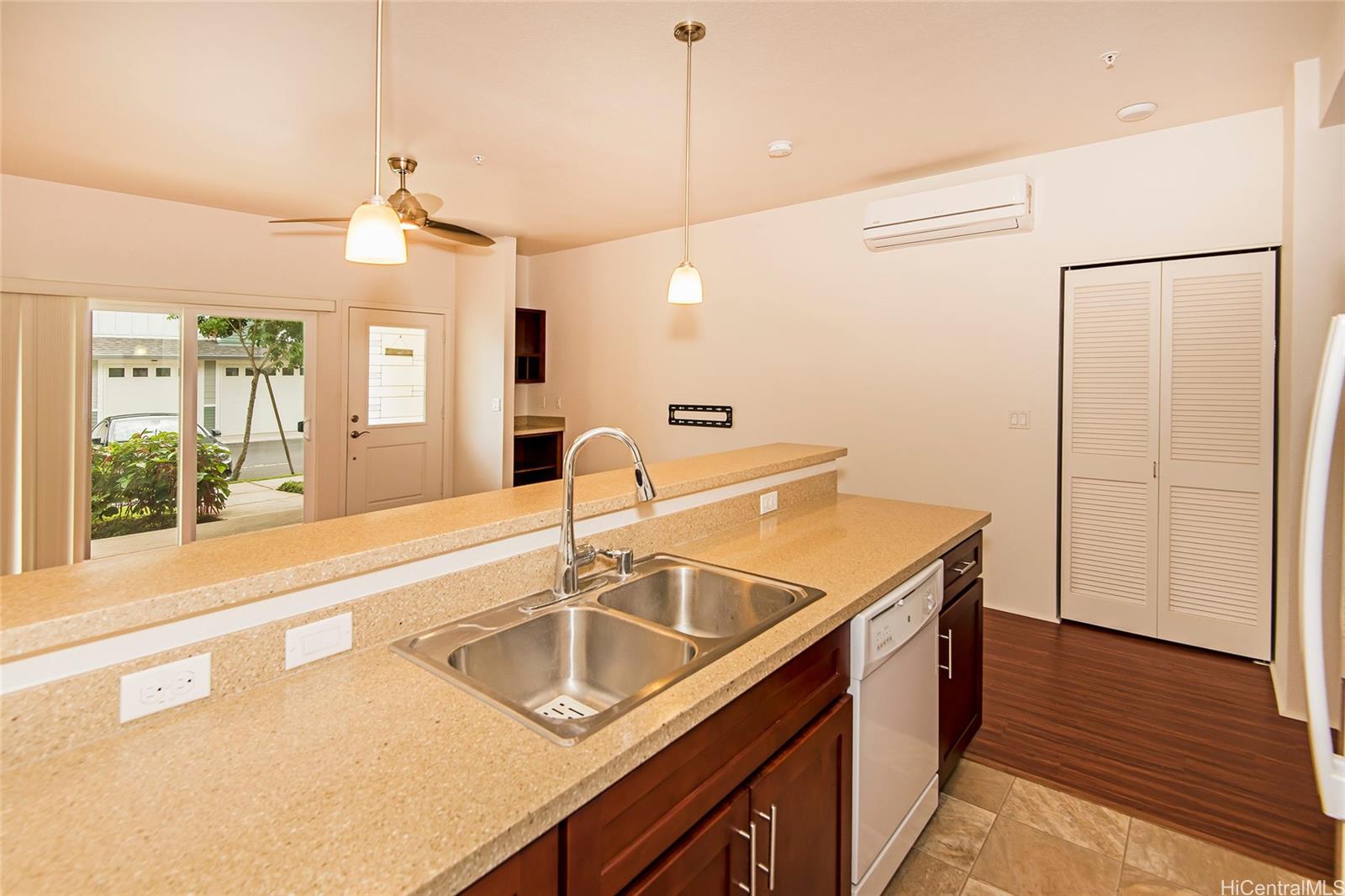 a kitchen with a sink a refrigerator and wooden floor