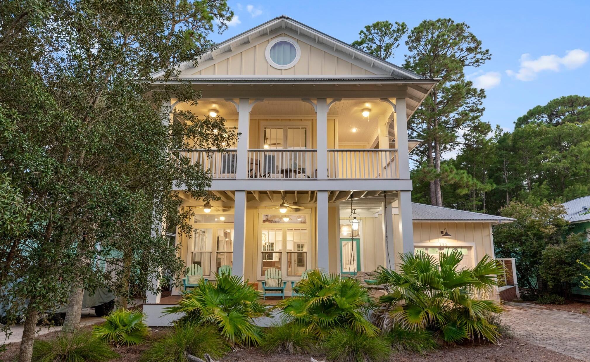 a front view of a house with a garden