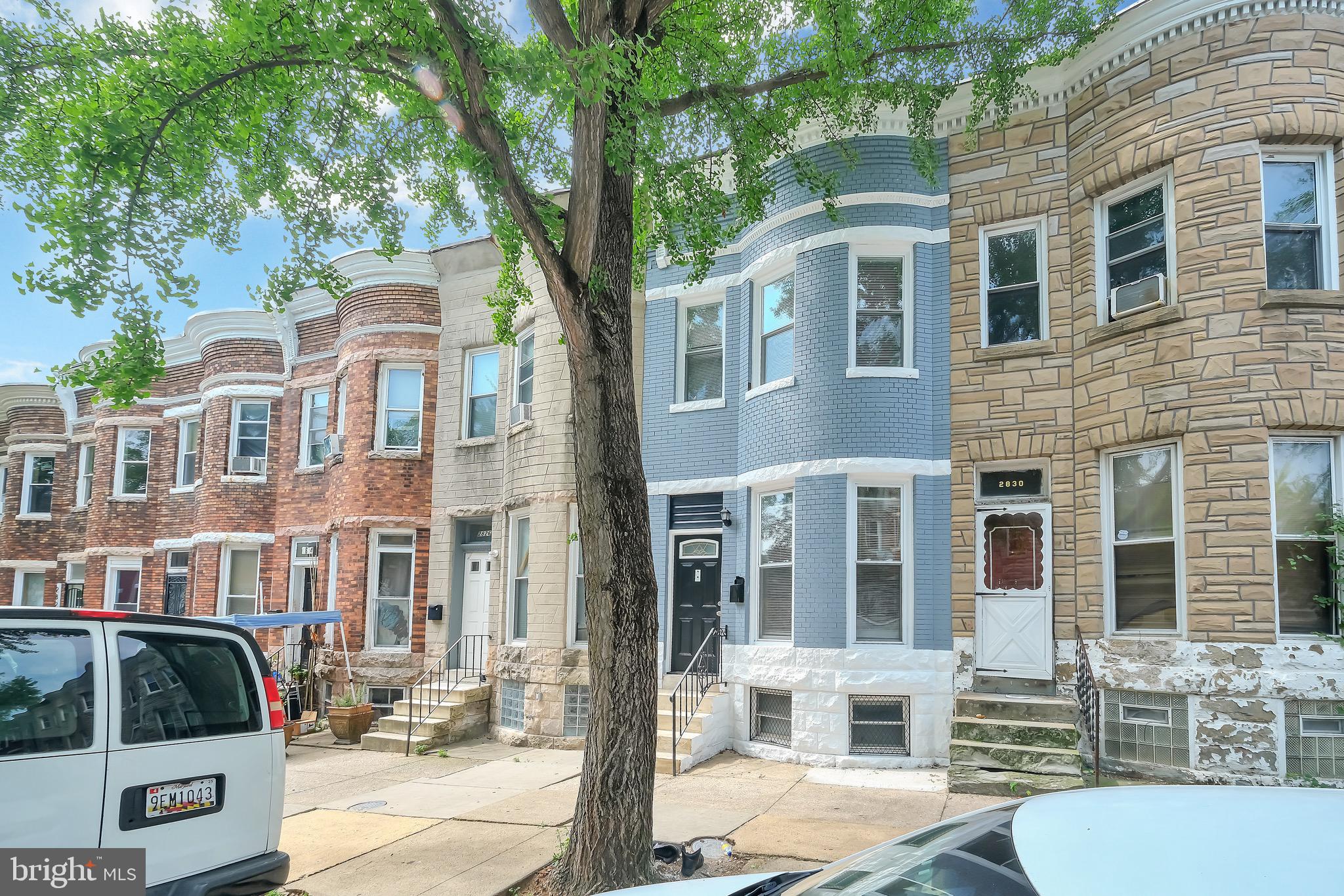 a front view of a residential apartment building with a yard