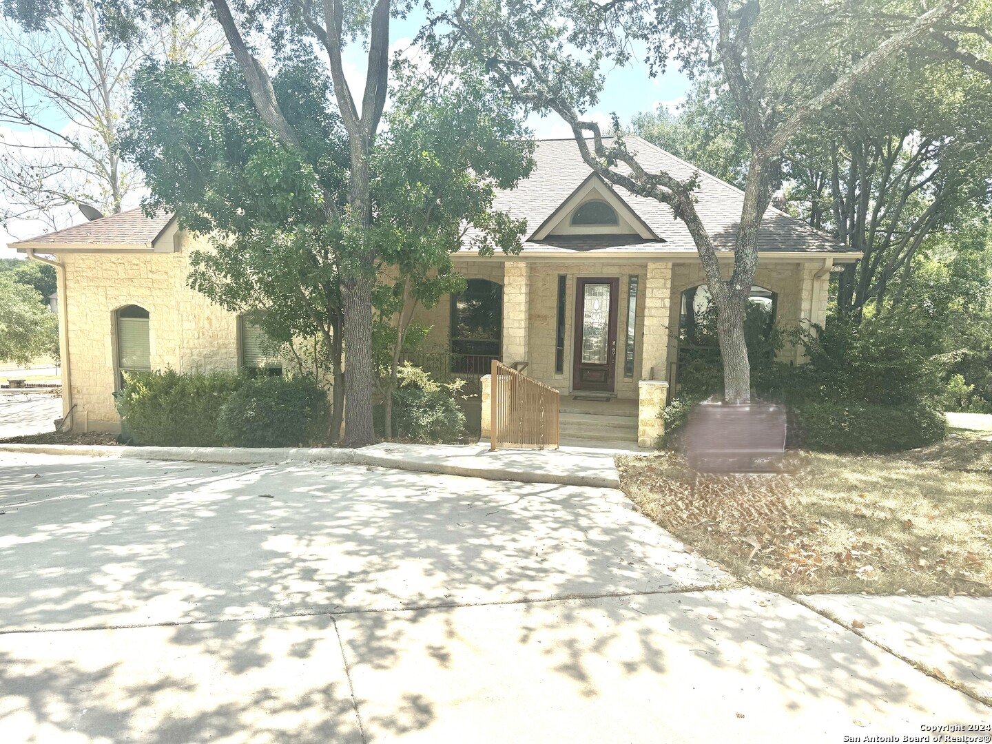 a view of a house with a yard and tree s