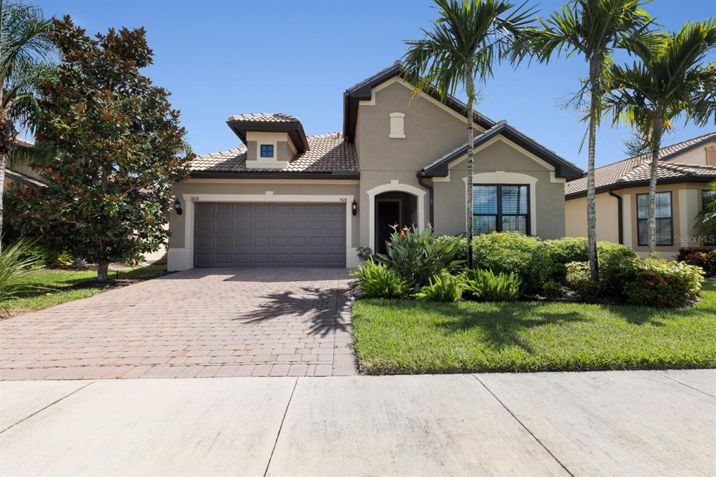 a front view of a house with a garden