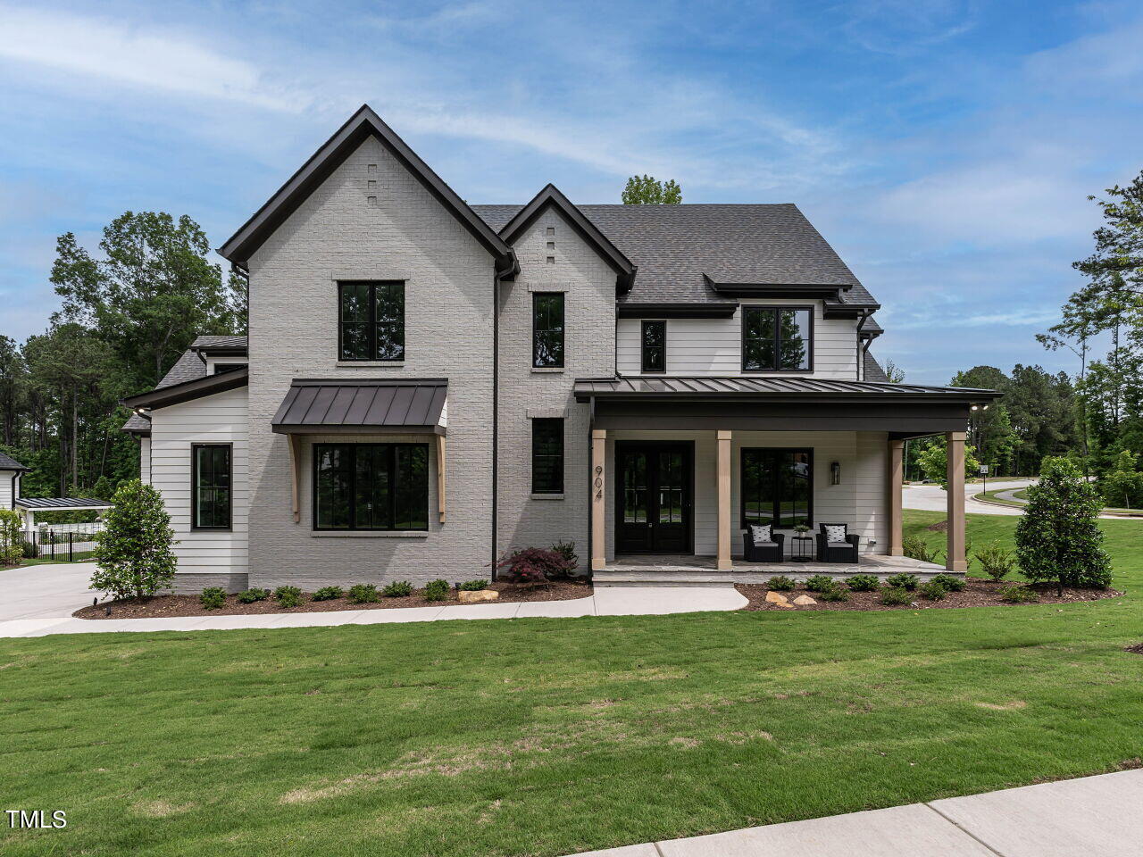 a front view of house with yard and outdoor seating