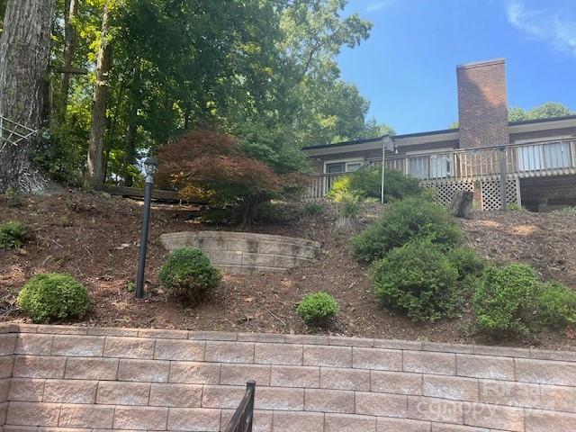 a front view of a house with plants and trees