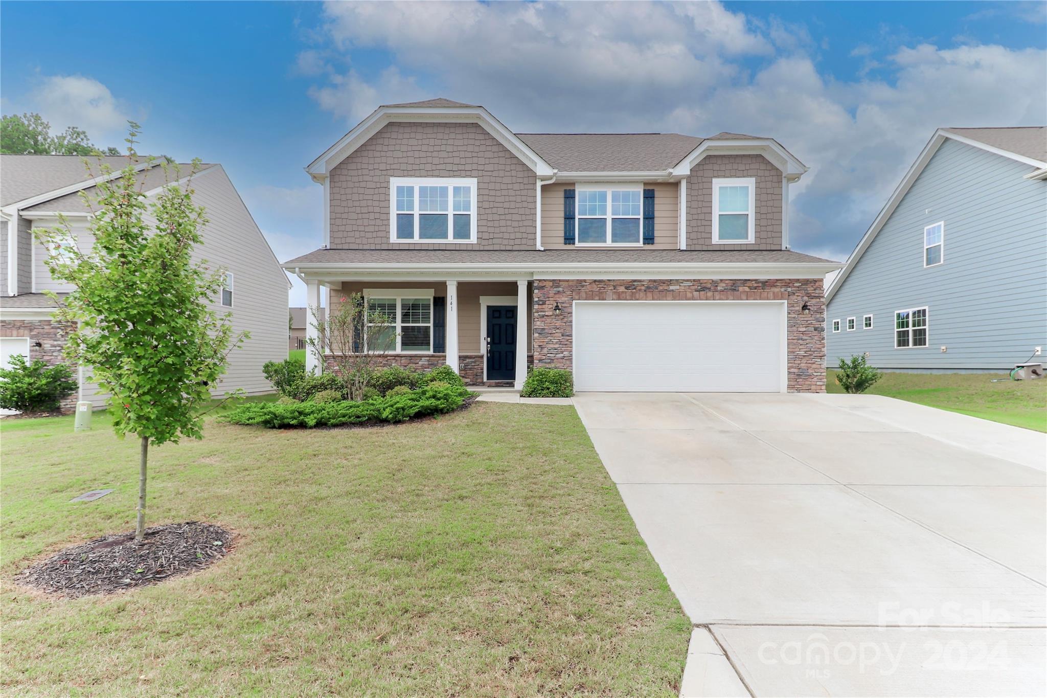 a front view of a house with a yard