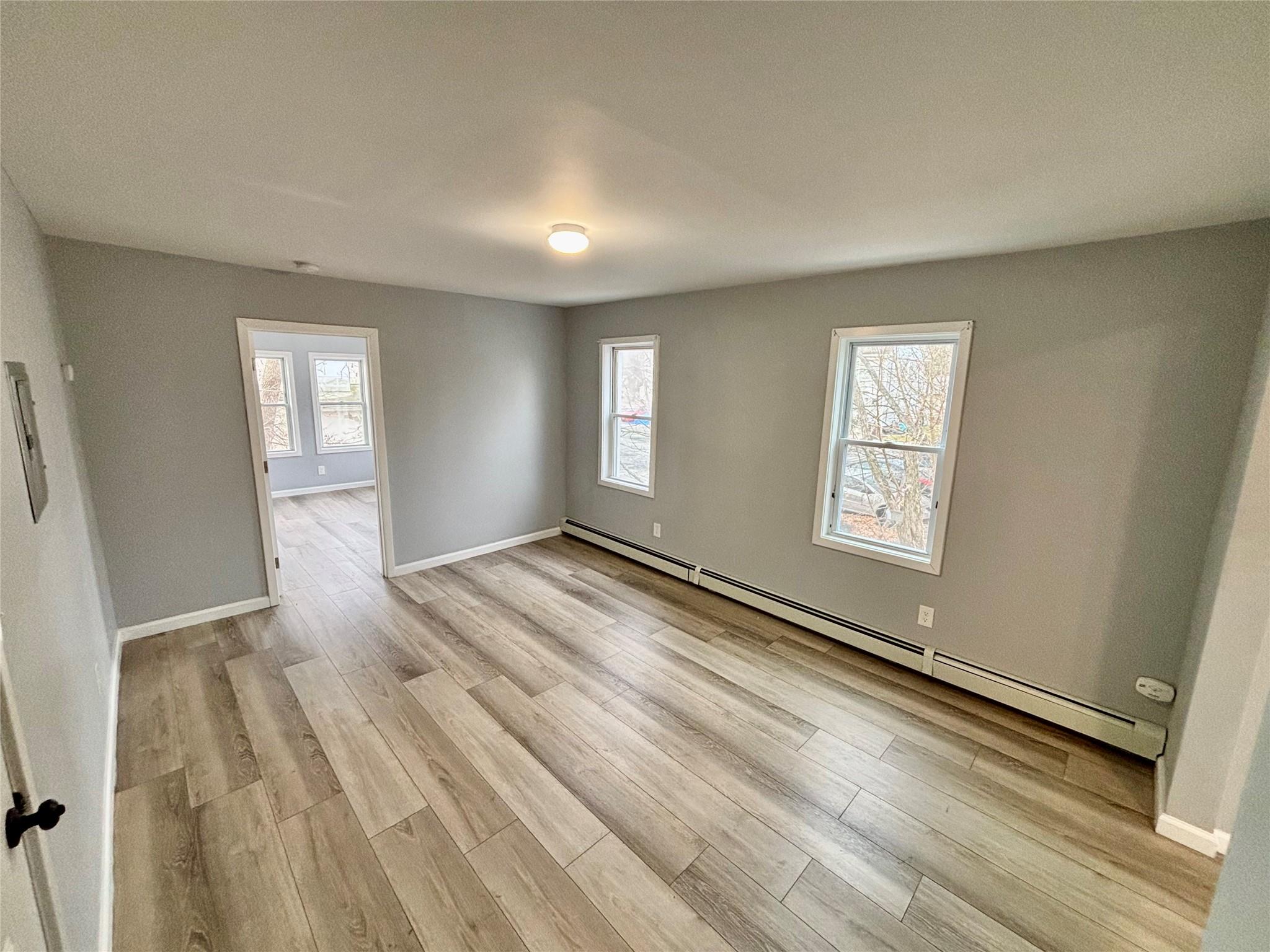 wooden floor in an empty room with a window