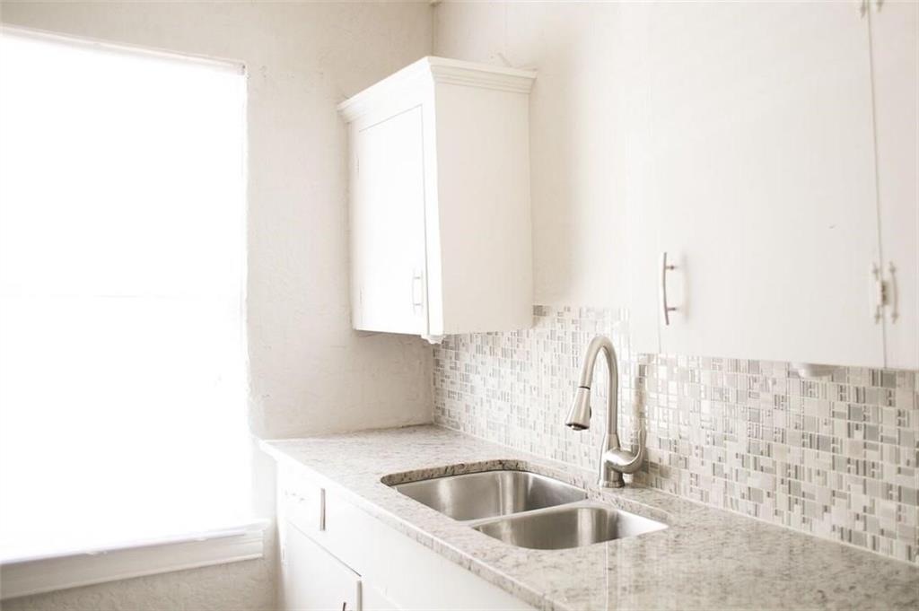 a bathroom with a sink and a window