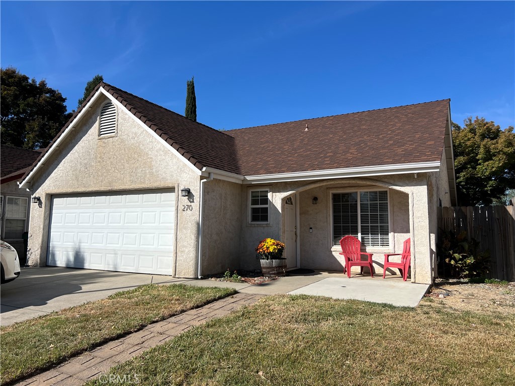 a view of a house with a yard and garage