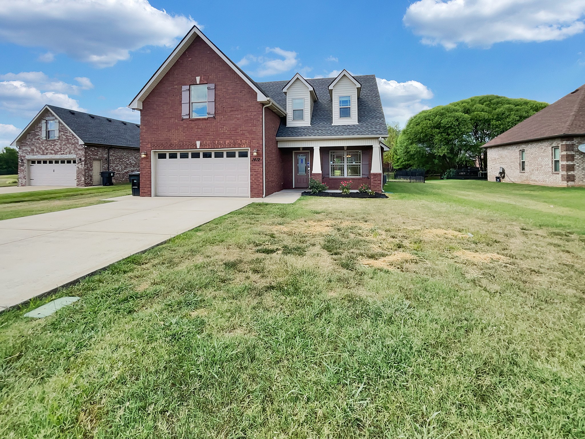 a front view of a house with a yard and garage